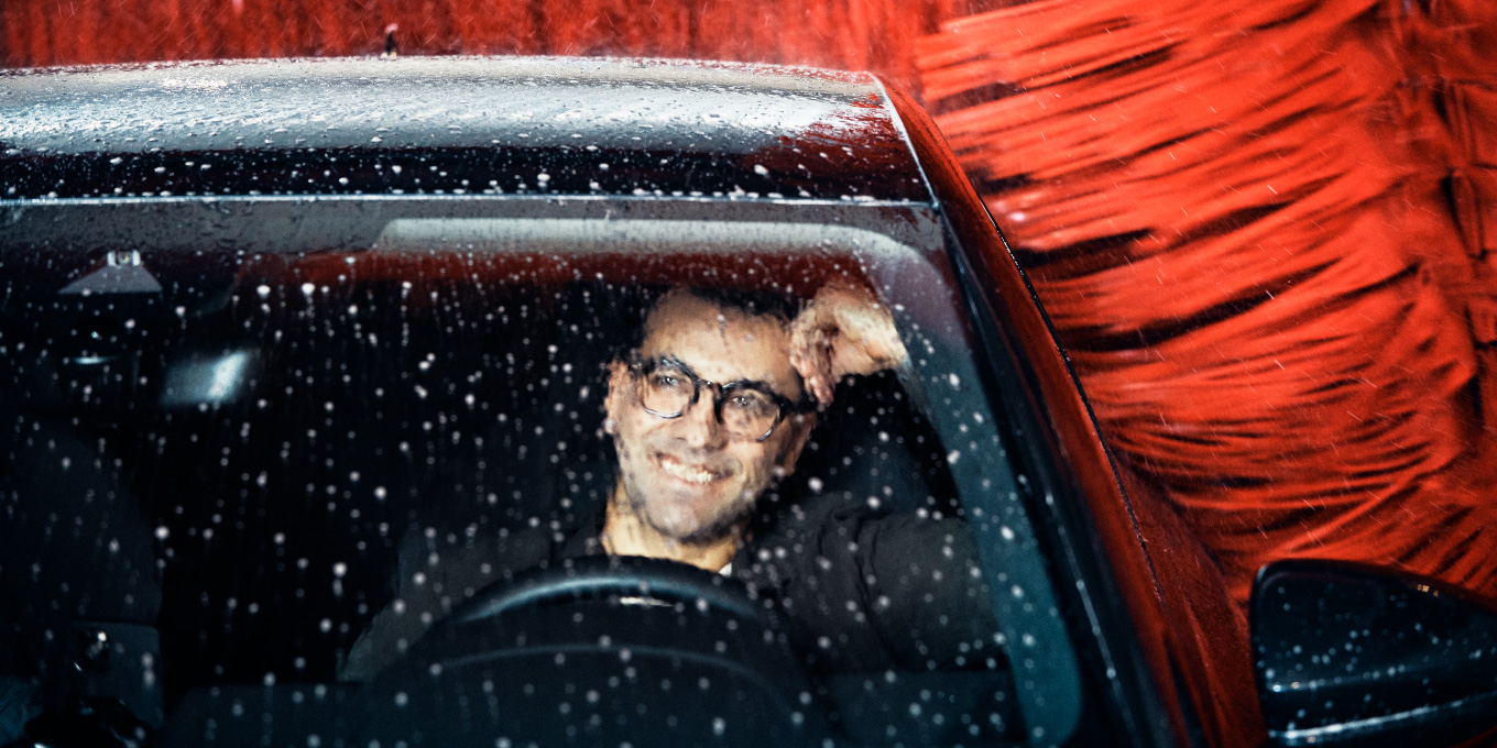 A man sitting in a car during a Circle K car wash