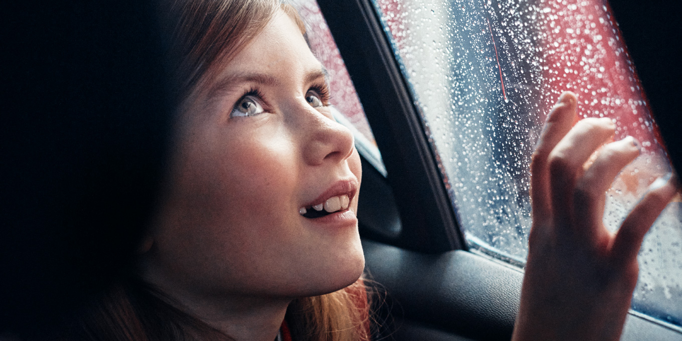 A girl sitting in a car during a Circle K car wash