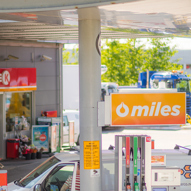 miles sign above fuel pumps