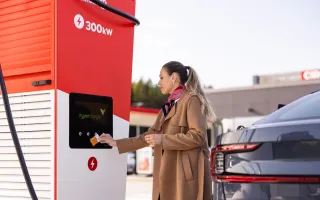 Woman charging her car at Circle K station