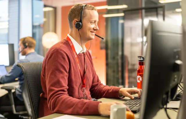 Man happily helping customers over the phone