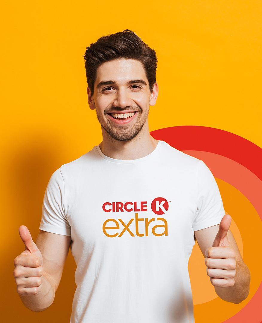 A happy man wearing a Circle K Extra T-shirt