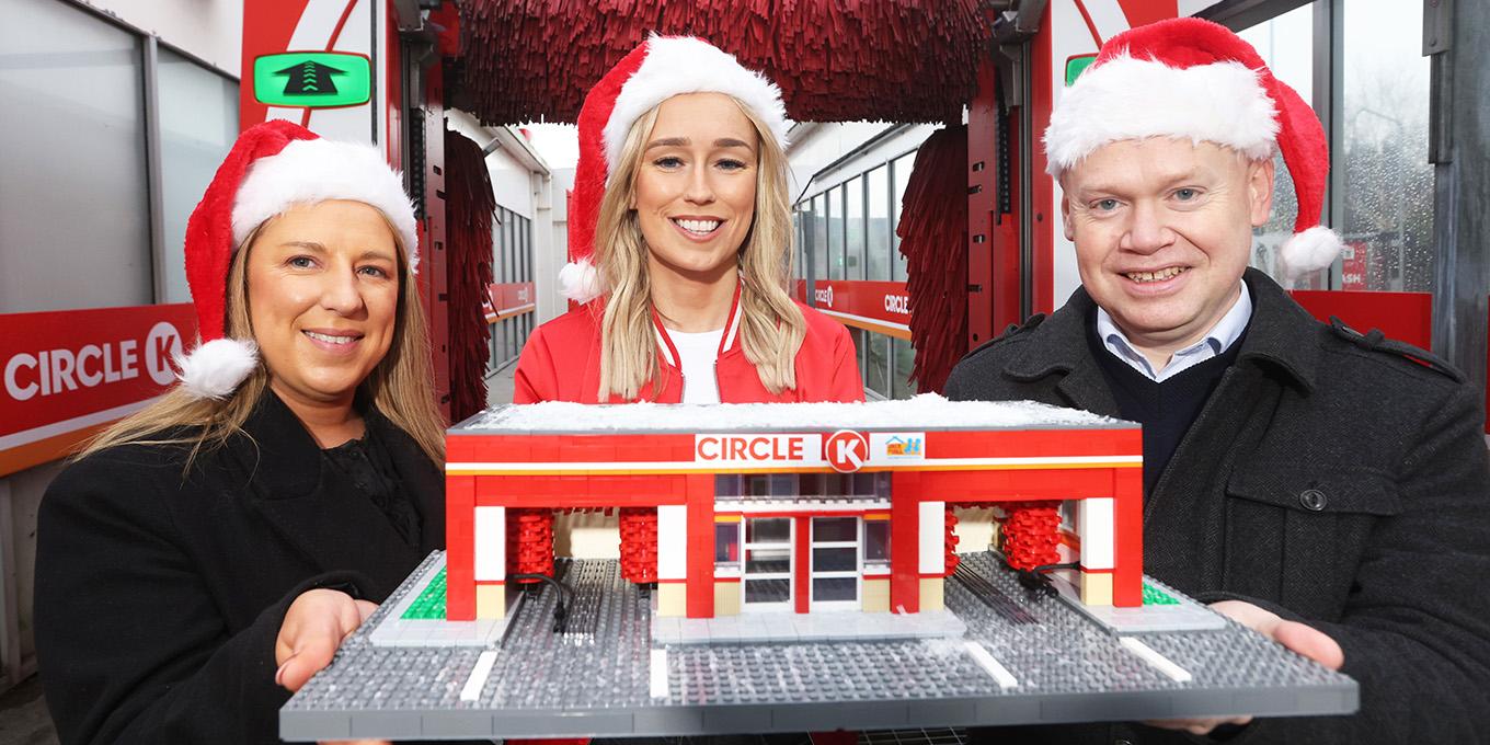 Alie Sheridan, Emmet Toft and Stephanie Roche holding a miniature of a CK station